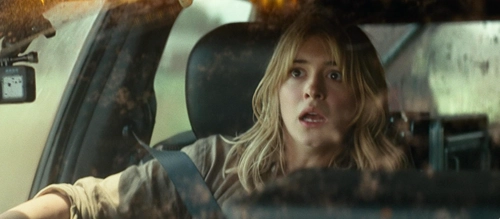 Daisy Edgar-Jones pushes back in her car seat at the sight of something scary off-screen. Film still.