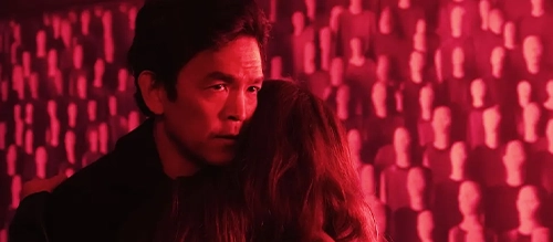 John Cho against a pink background in 'Afraid' (2024).