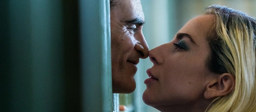 Joaquin Phoenix and Lady Gaga lean in to kiss in 'Joker: Folie a Deux' (2024).